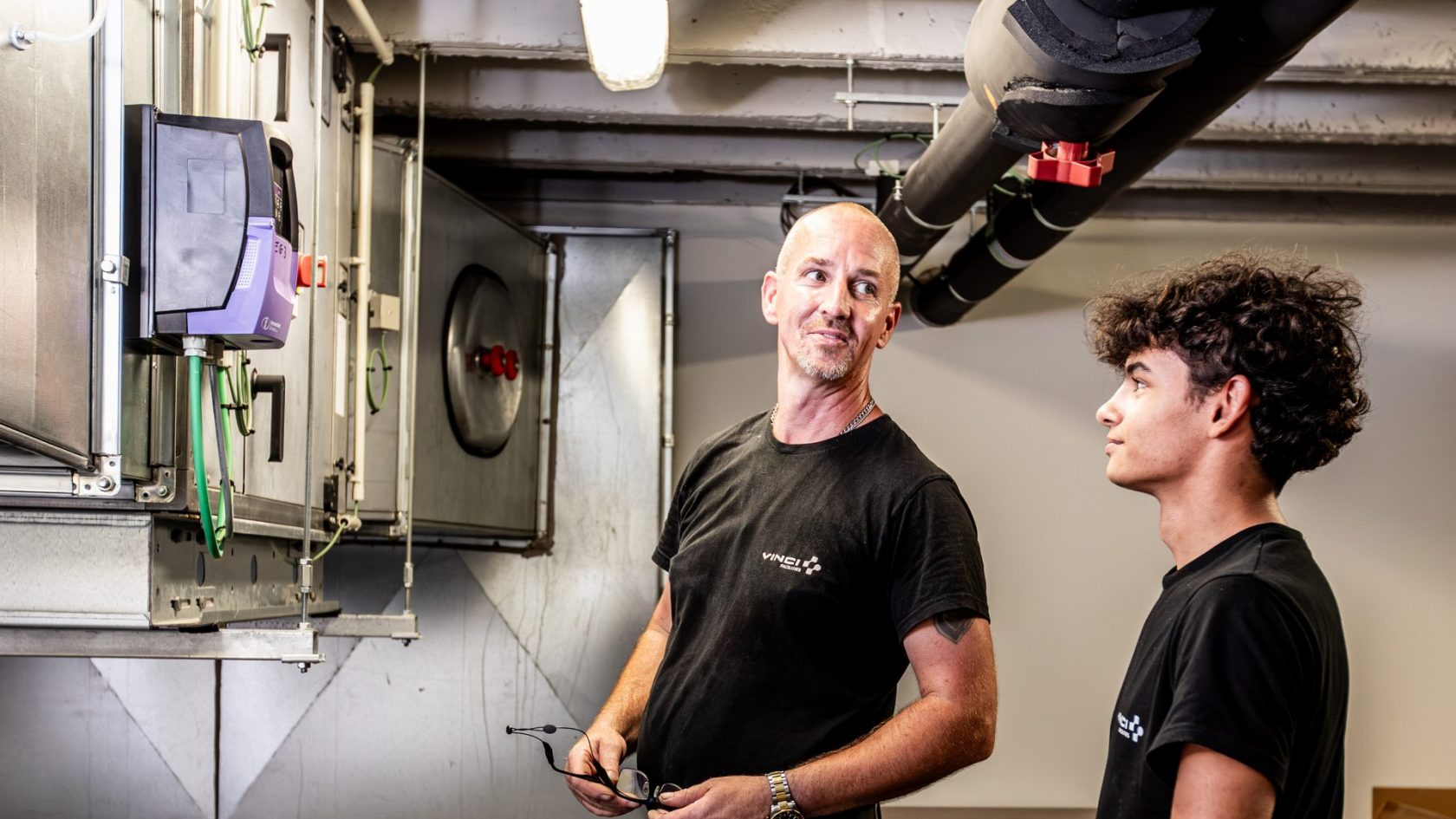 VINCI Facilities technicians inspecting building systems