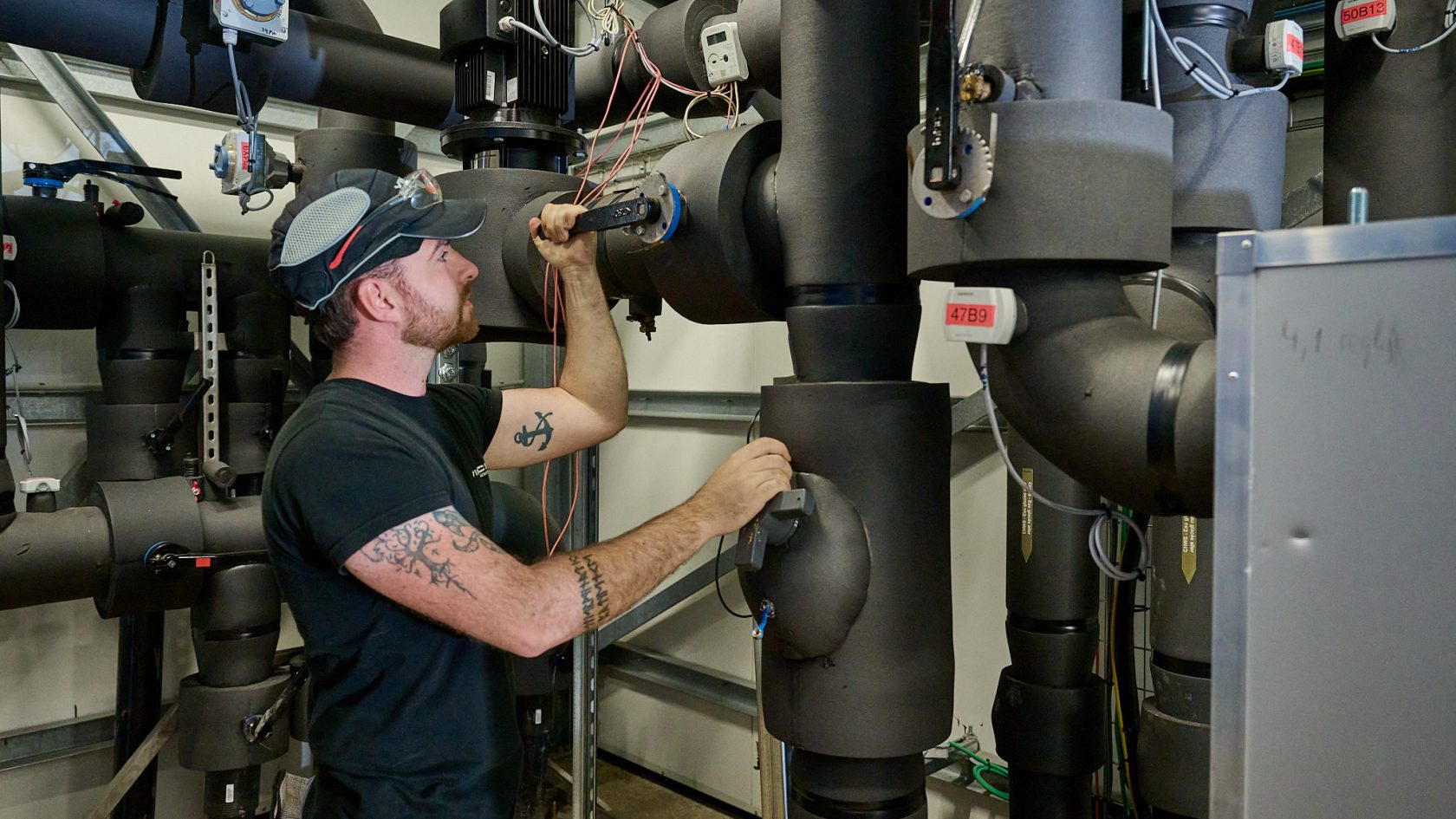 VINCI Facilities technician inspecting pipes and technical installations